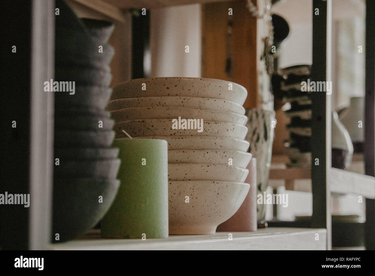 Stack of ceramic plates on cozy background Stock Photo - Alamy