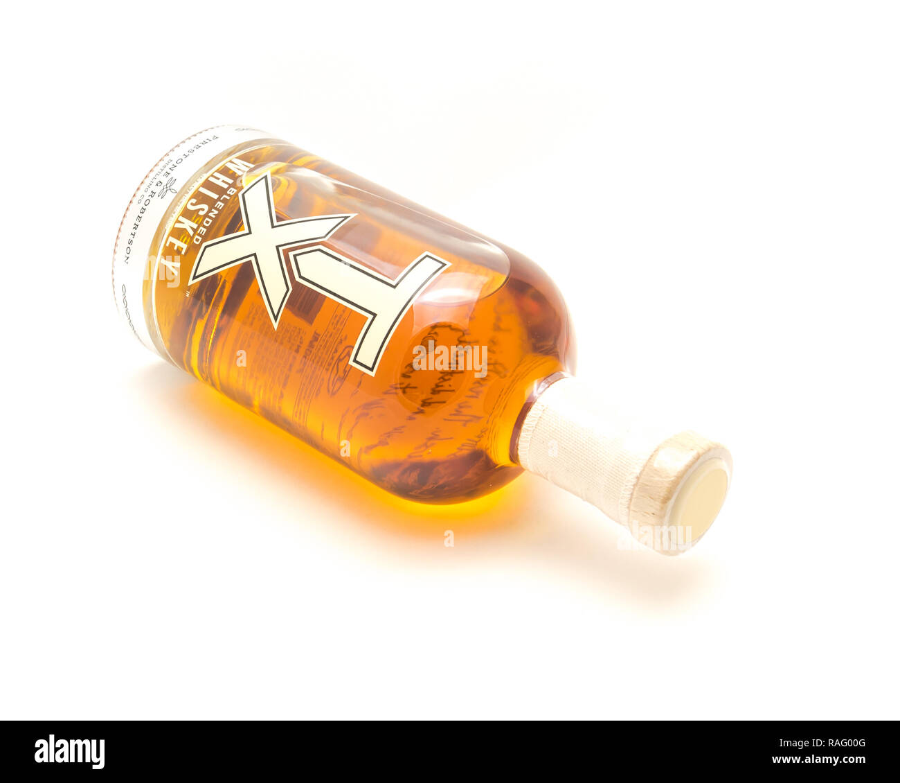 Lying bottle of TX Blended Whiskey isolated on white from Firest Stock