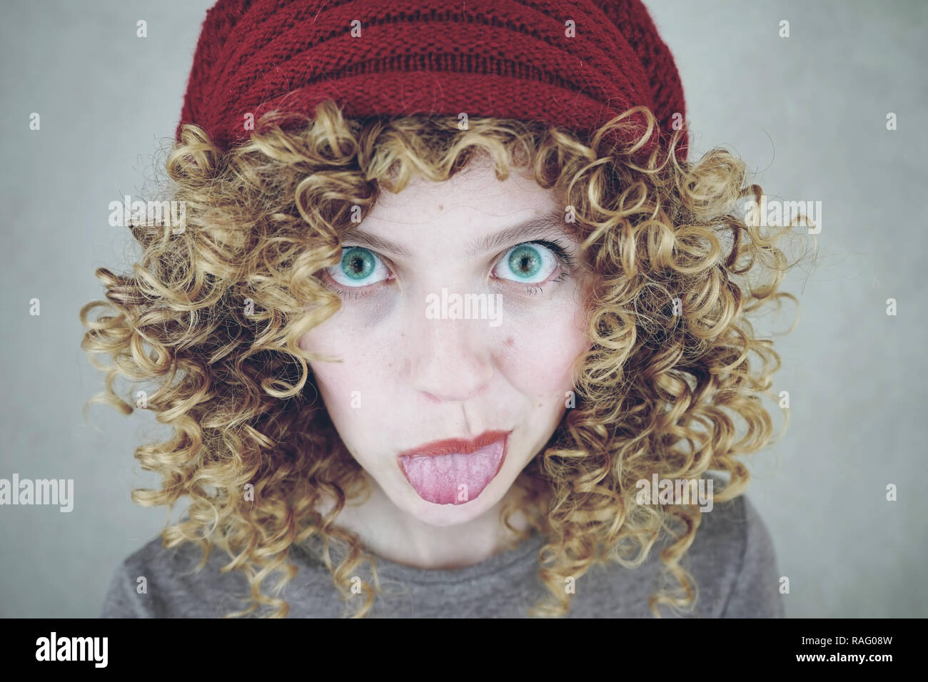 Close Up Portrait Of A Beautiful And Funny Young Woman With Blue