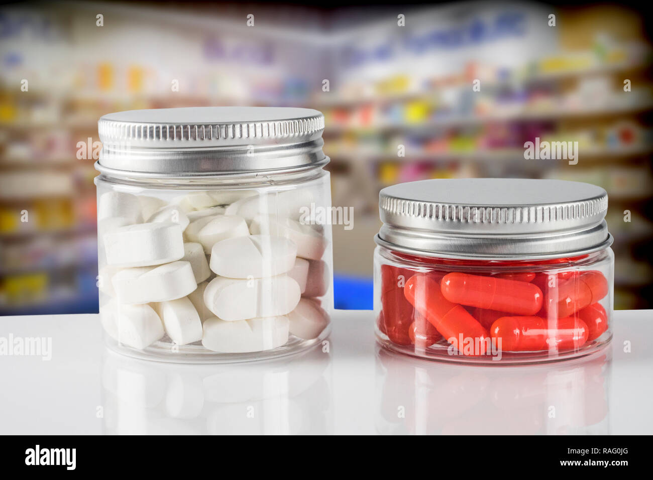 Two containers of medication in capsules and tablets in a pharmacy