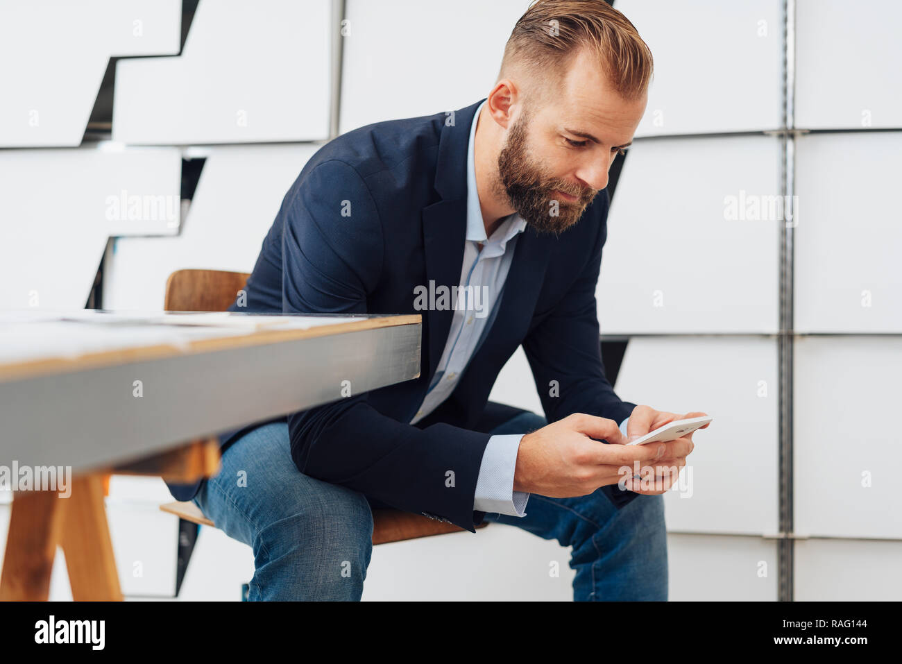 Bearded Young Handsome Businessman Looking At His Smartphone