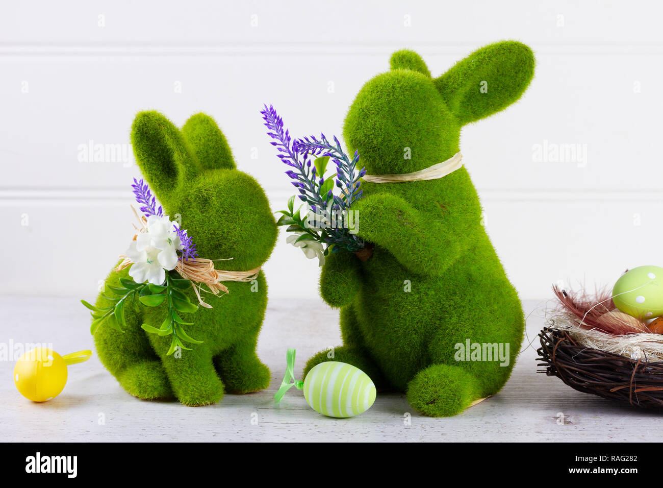 Easter scene with colored eggs in nest and two green bunnies Stock ...
