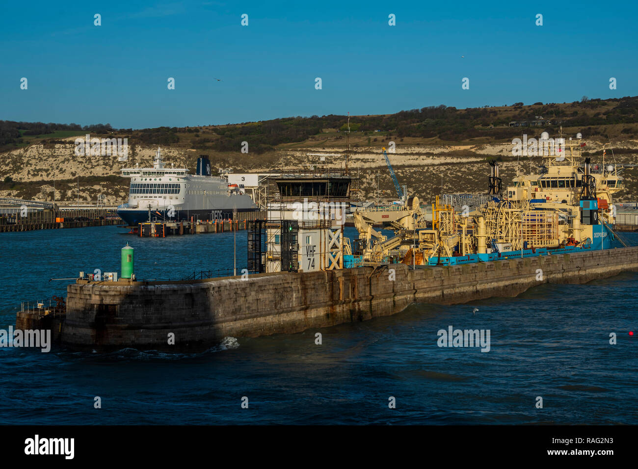 Ferries sail in and out of the busy port - The Christmas get away is in full flow as the sun rises over Dover and the ferries crossing to Calais. Stock Photo