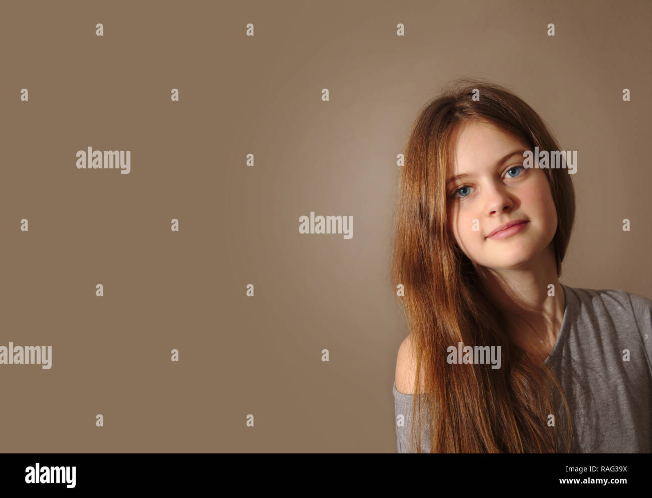 blue eyed brown haired shy girl with flowing hair Stock Photo - Alamy