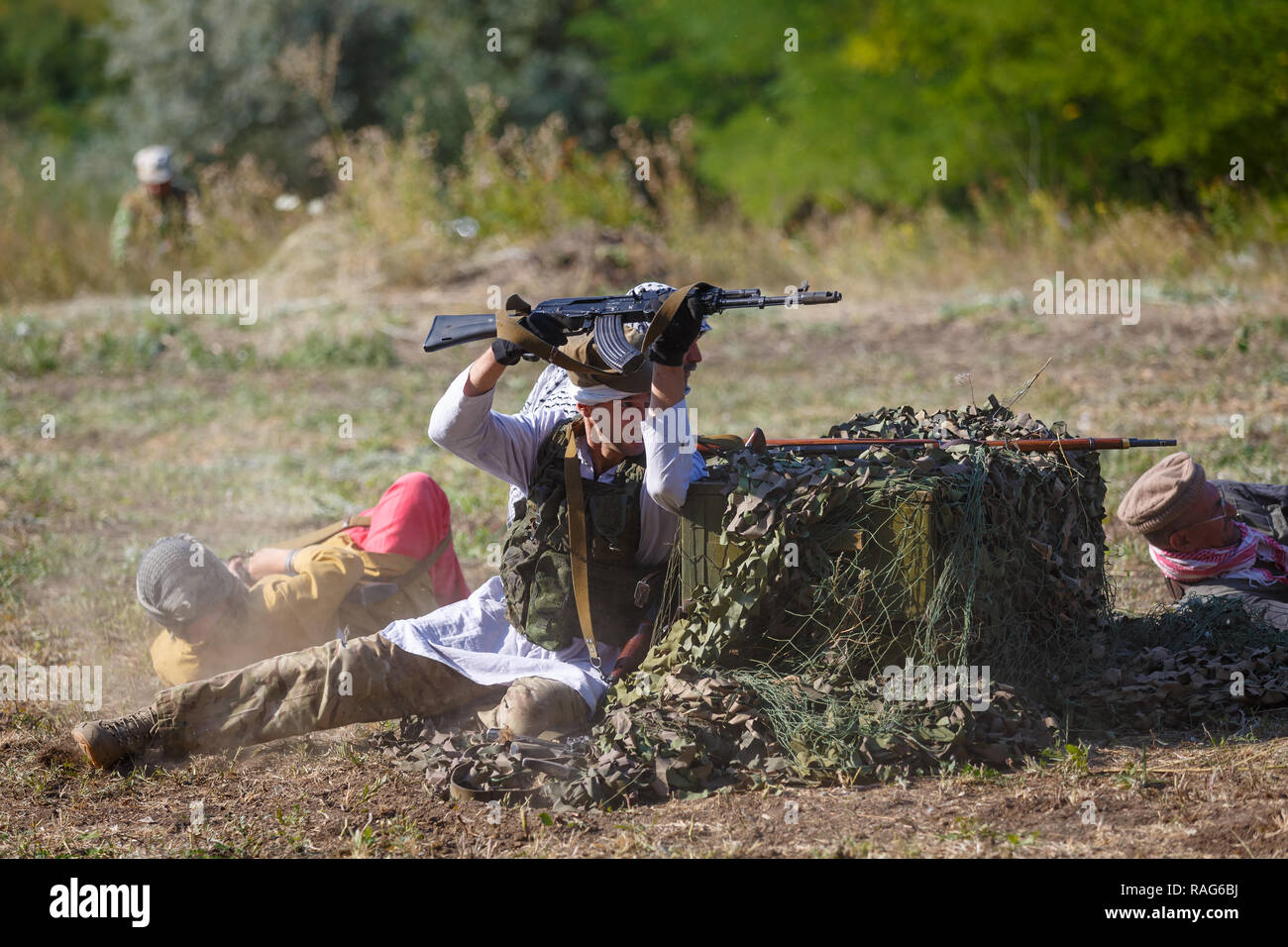 Historical festival Sambek Heights. Mujahideen shoot from behind cover Stock Photo