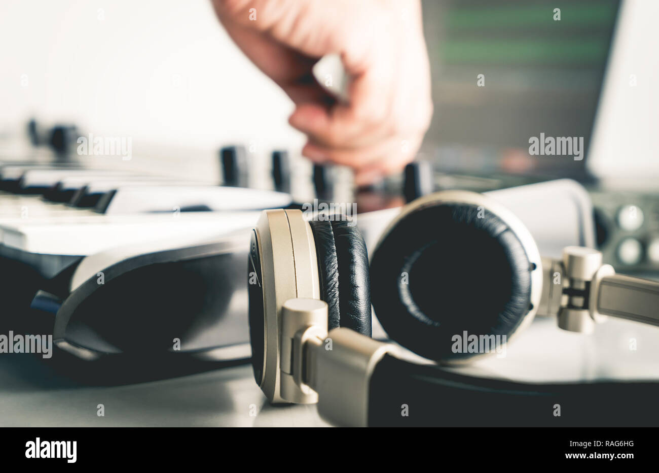 Musician is mixing and adjusting track on Portable Computer Music Studio home set up Stock Photo