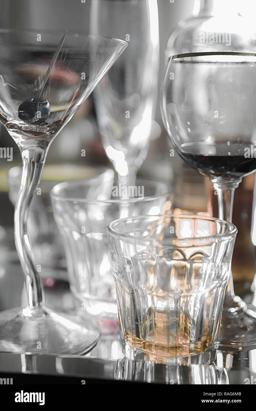 Close up on almost empty alcohol glasses on a tray. End of party. Early morning. Stock Photo