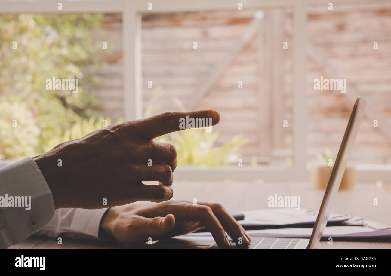 Closed up hand pointing on computer laptop Stock Photo - Alamy