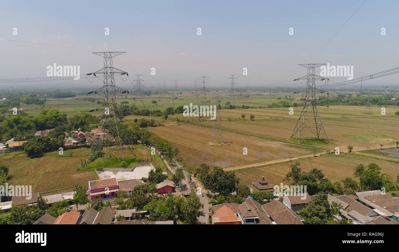 Electricity pylons bearing power supply across agricultural land with ...