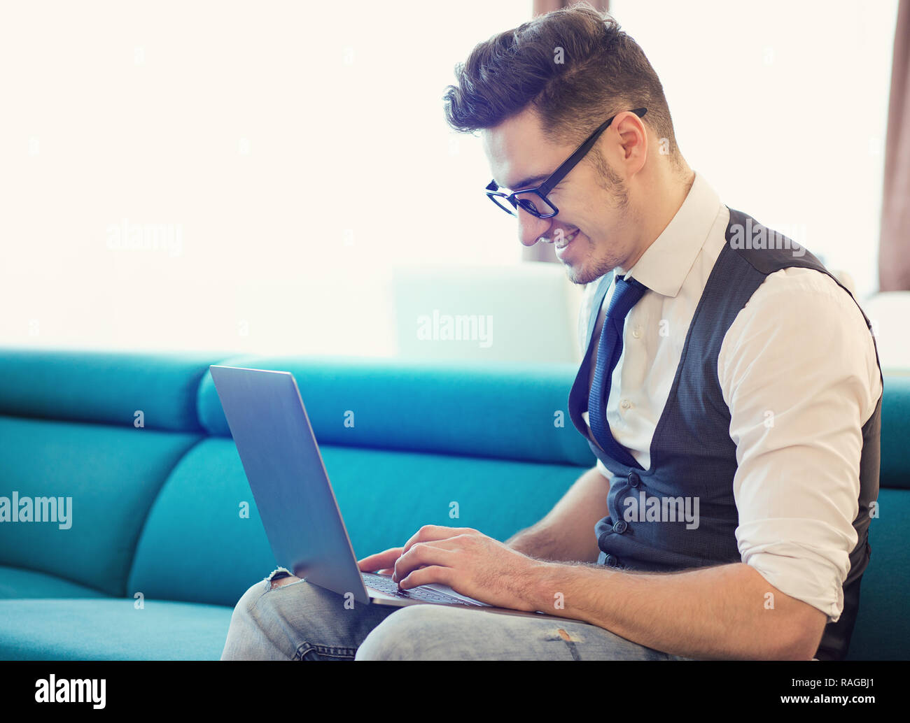 Man sitting couch smiling hi-res stock photography and images - Alamy