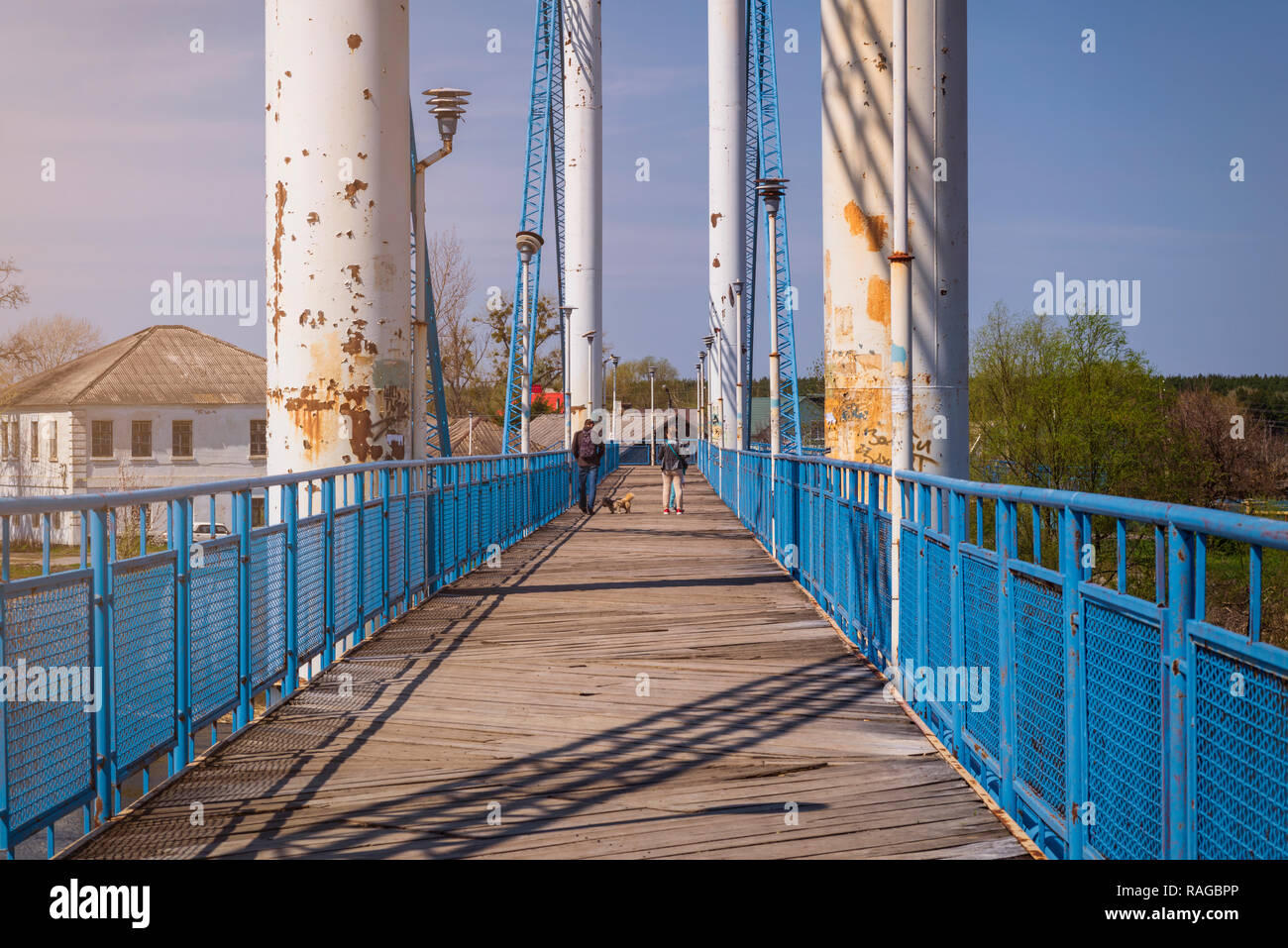 Bridge and wooden walkway across the river Stock Photo - Alamy