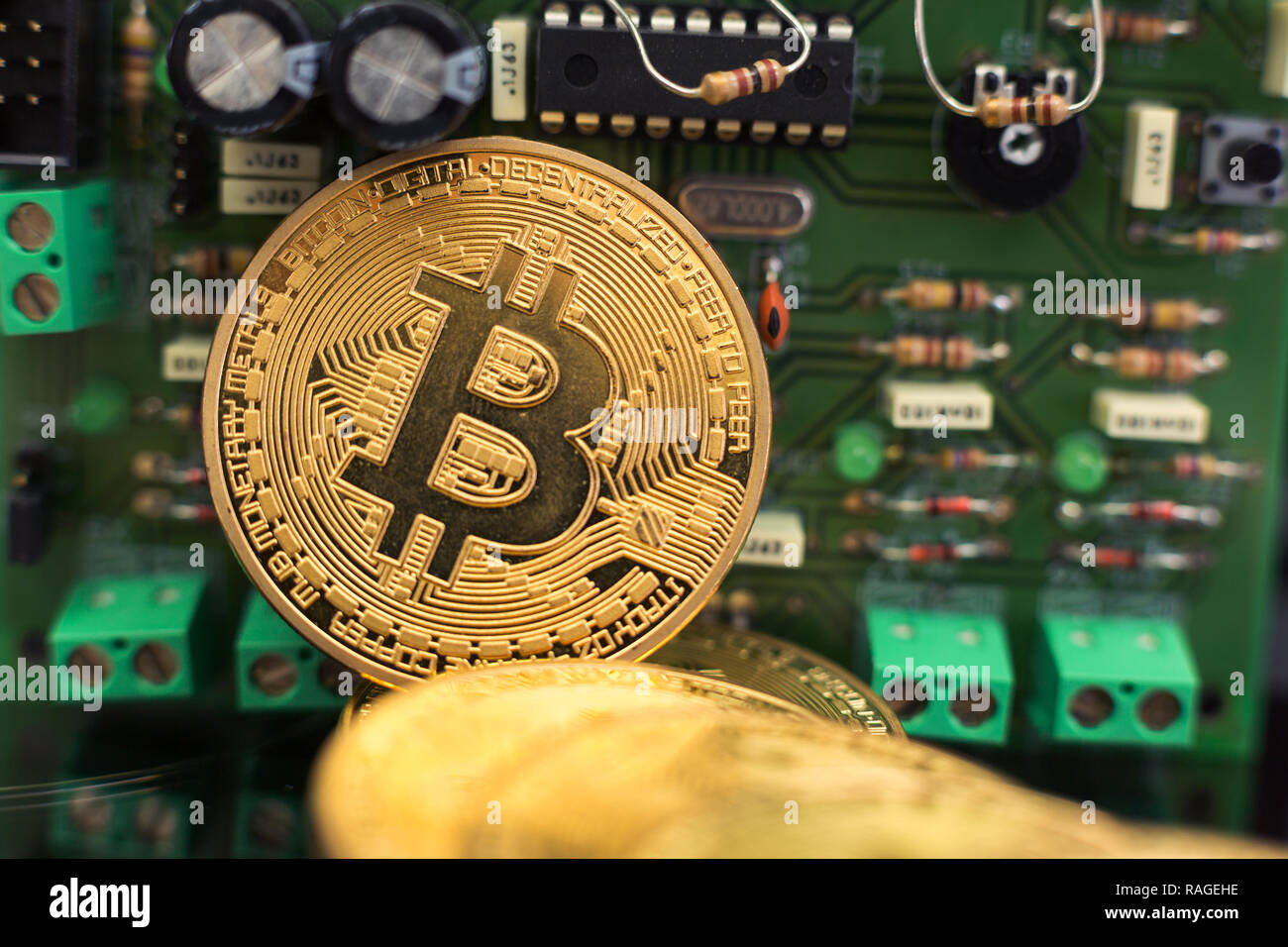 Bitcoin gold coin on computer circuit board microchips. Electronic cryptocurrency. Stock Photo