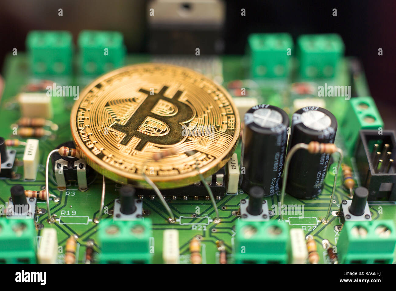 Bitcoin gold coin on computer circuit board microchips. Electronic ...