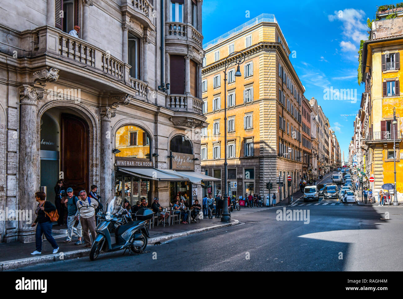 Rome, Italy - September 29 2018: Tourists enjoy lunch at a sidewalk cafe on a busy intersection in the historic center of Rome, Italy. Stock Photo