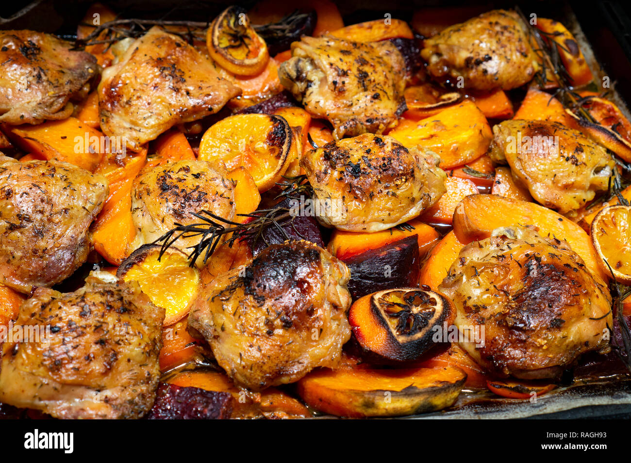 oven Baked chicken legs thighs with sweet potato, oranges and rosemary, top view Stock Photo Alamy