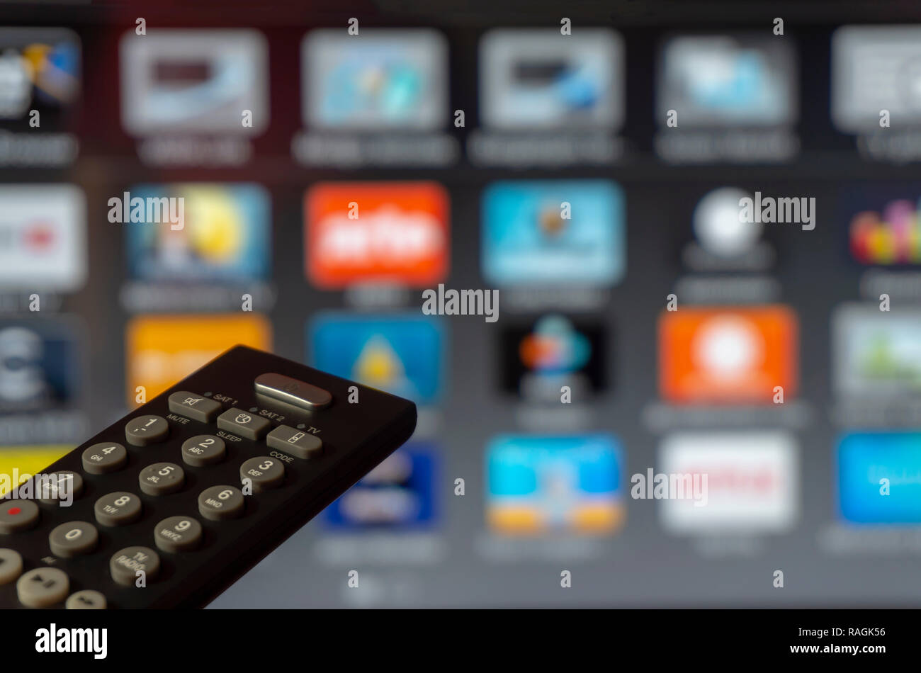 Smart television screen with close up tv remote control in foreground Stock Photo