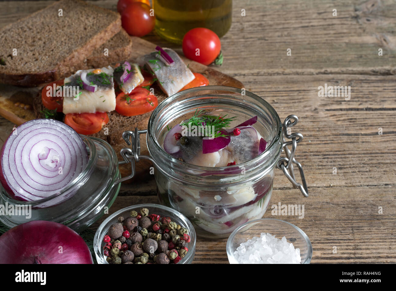 homemade pickled herring fillet in a jar and sandwiches with herring