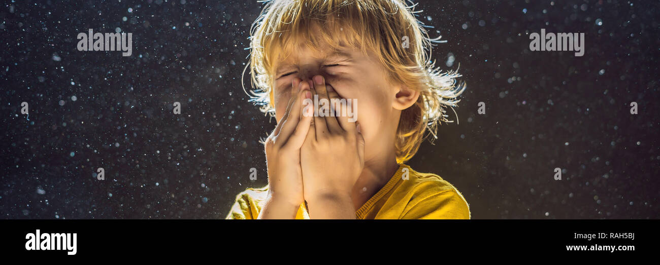 Allergy to dust. Boy sneezes because he is allergic to dust. Dust flies