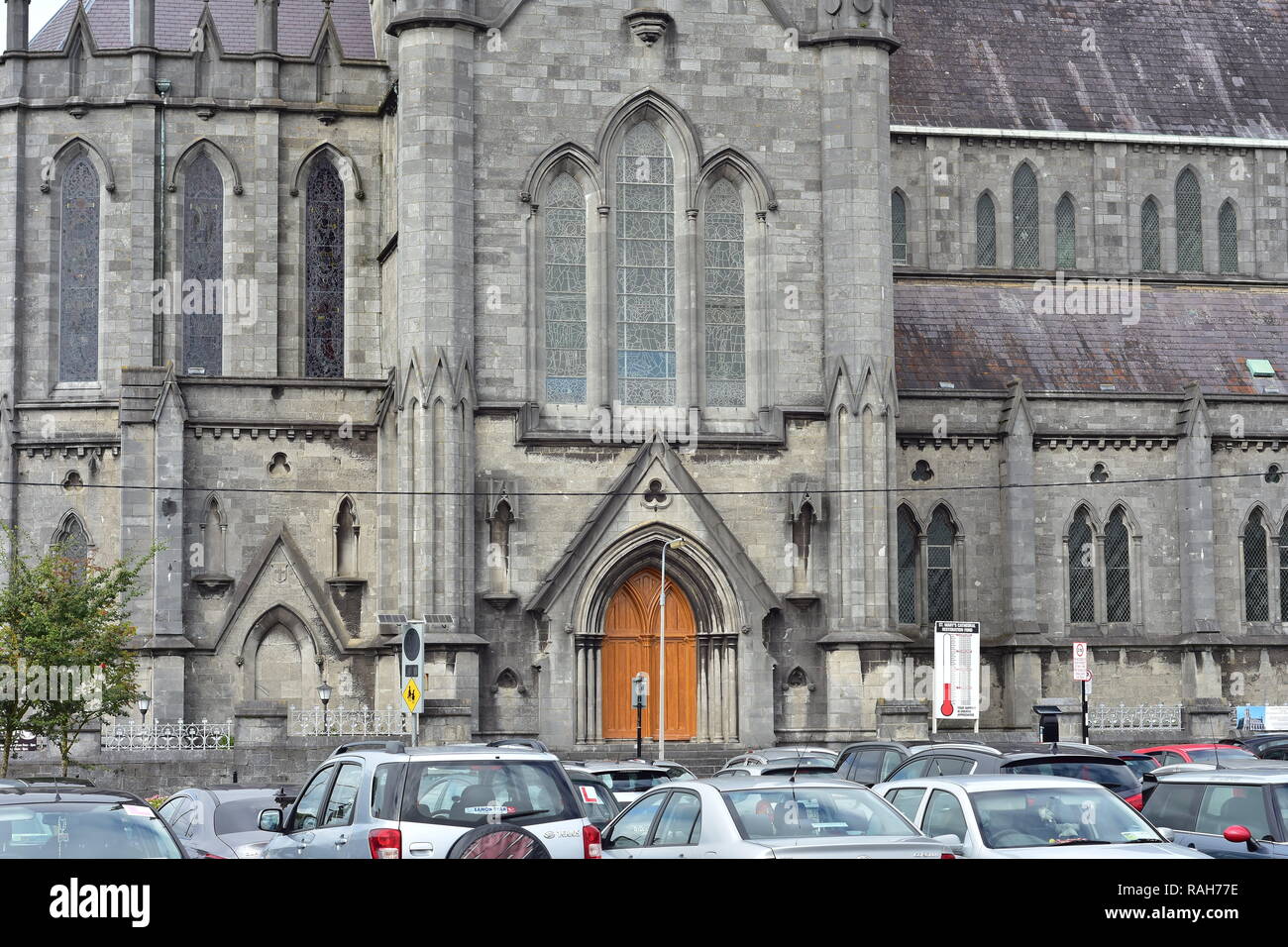 Exterior of gothic stone building with wooden gate and arched windows of Saint Mary cathedral in