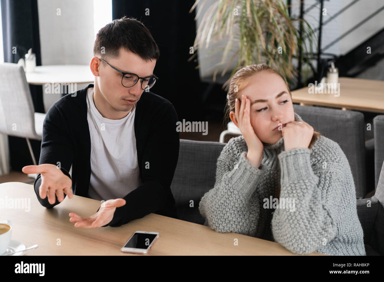 Annoyed man trying to explain something to his wife Stock Photo