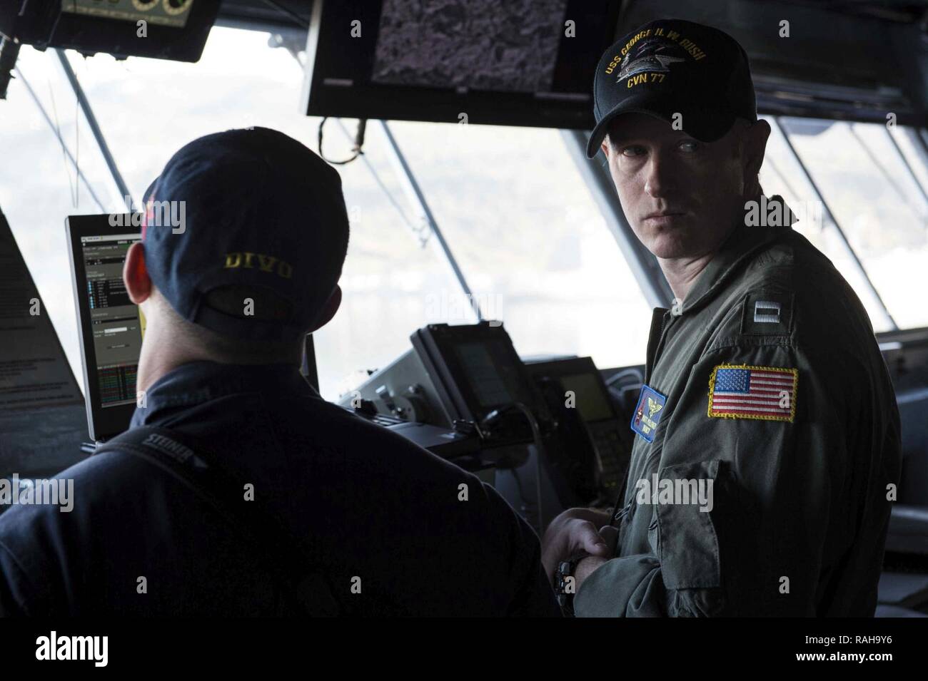 SOUDA BAY, Greece (Feb. 6, 2017) Ens. Tommy Madera, left, and Lt. Matt Pelonzi stands watch on the bridge aboard the aircraft carrier USS George H.W. Bush (CVN 77) as the ship arrives in Souda Bay, Greece. The ship's carrier strike group is conducting naval operations in the U.S. 6th Fleet area of operations in support of U.S. national security interests. Stock Photo