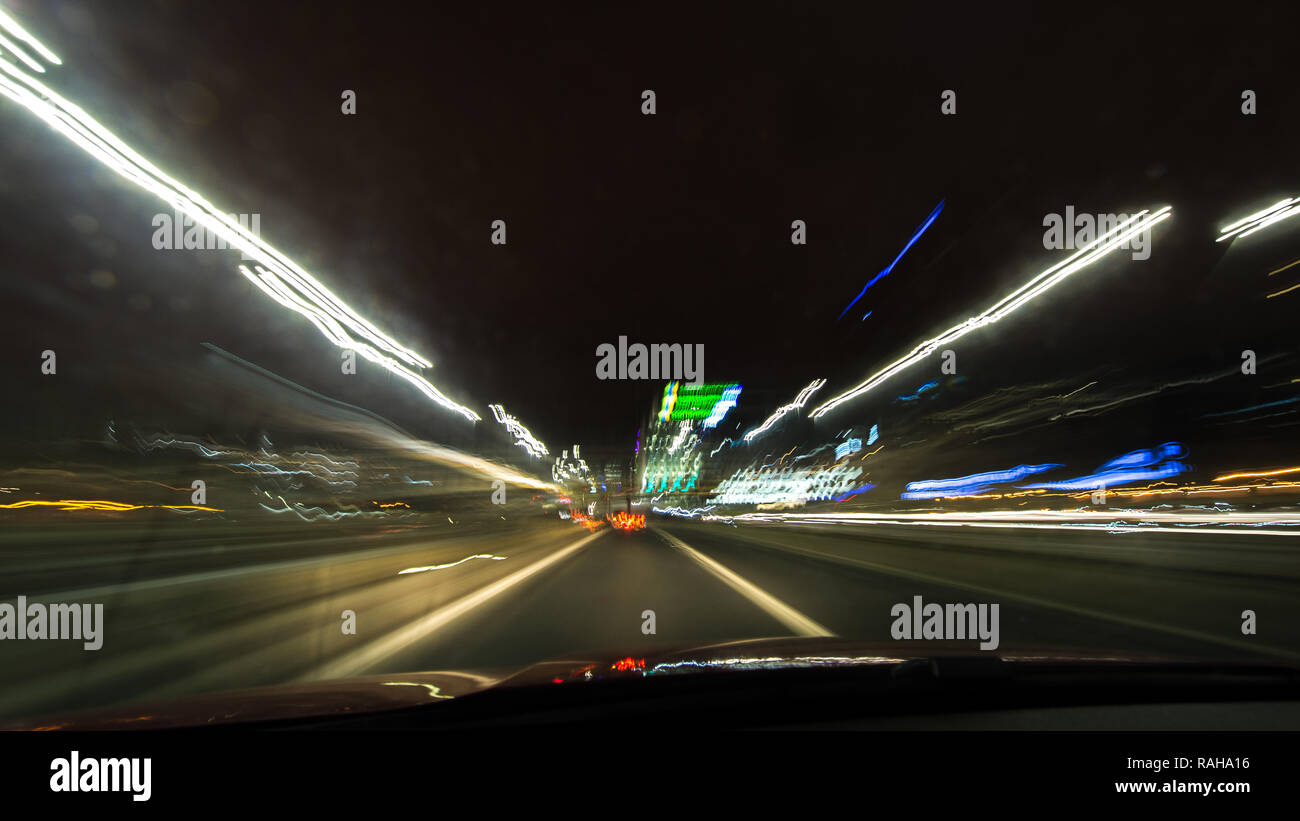 Driving on the M8 Motorway through Glasgow at night taken on a slow exposure camera setting to show the motion blur and speed of the car. Glasgow, UK  Stock Photo