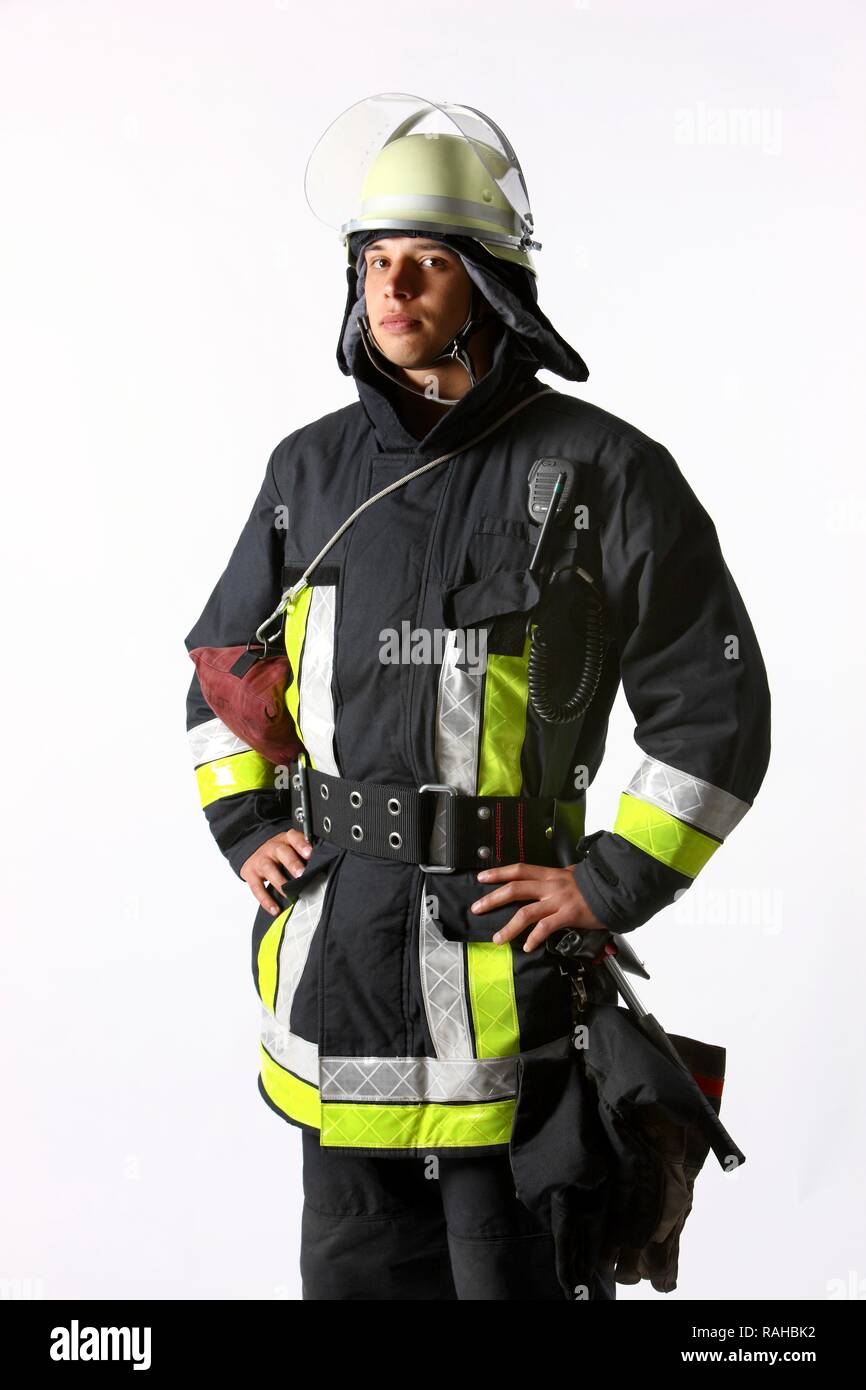 Firefighter wearing a uniform with basic equipment, protective clothing made of Nomex, a helmet with a visor, an equipment belt, Stock Photo