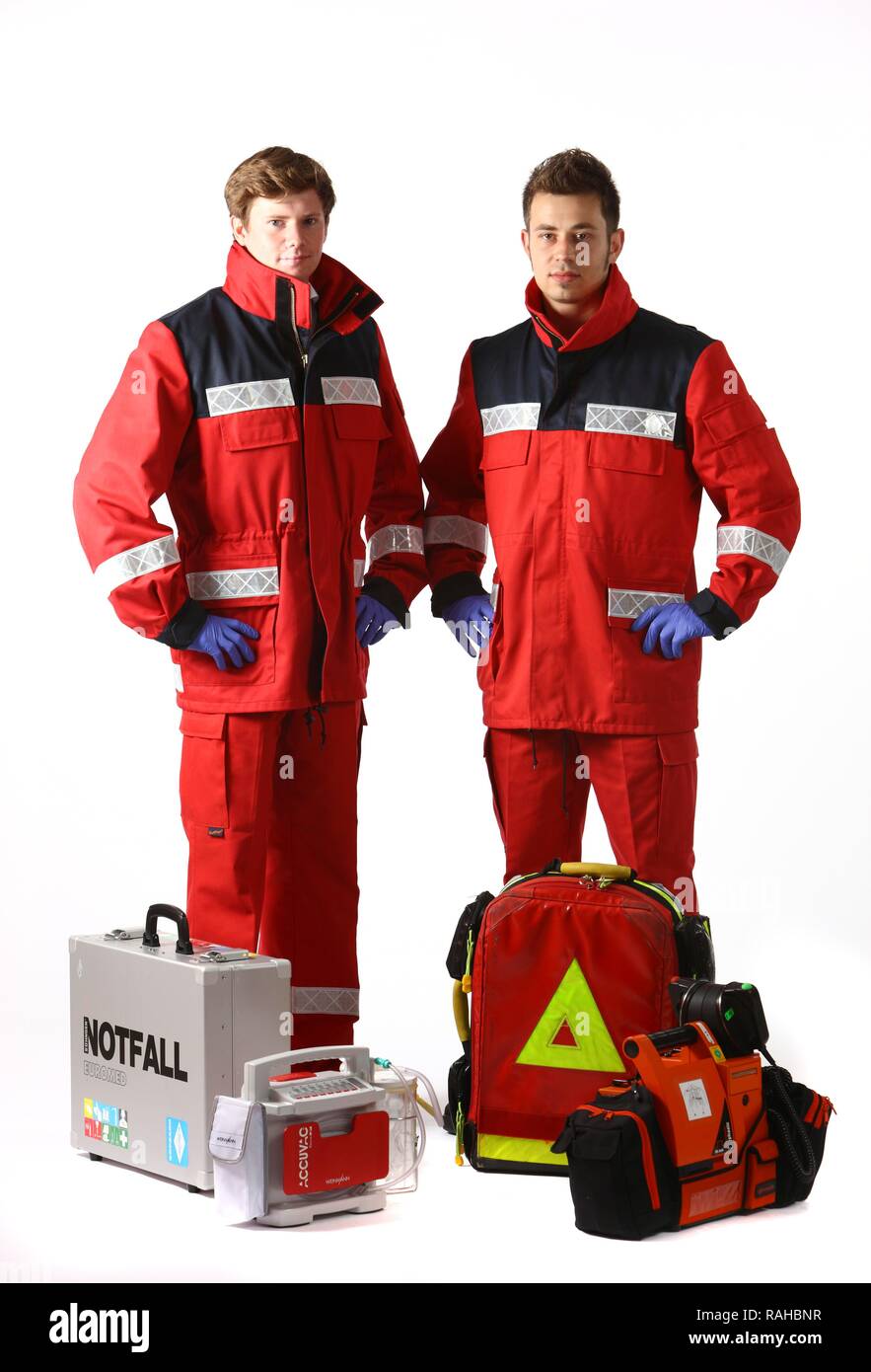 Paramedics with emergency equipment, first aid kit with bandages, medication, a defibrillator, ECG, breathing apparatus, Stock Photo