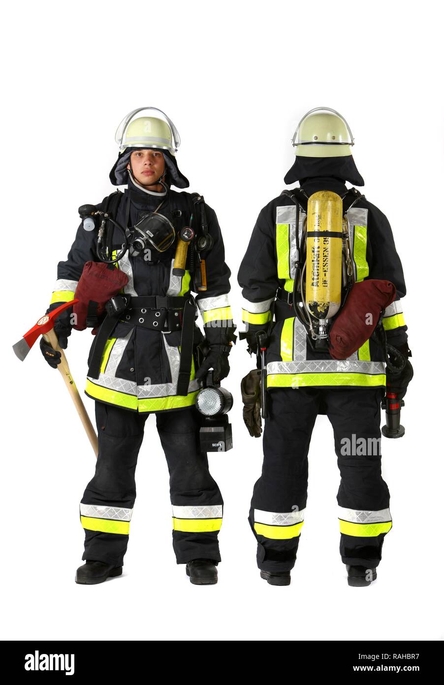 Firemen, part of a response squad for firefighting, with protective clothing made of Nomex, a helmet with a visor, a fire axe, Stock Photo