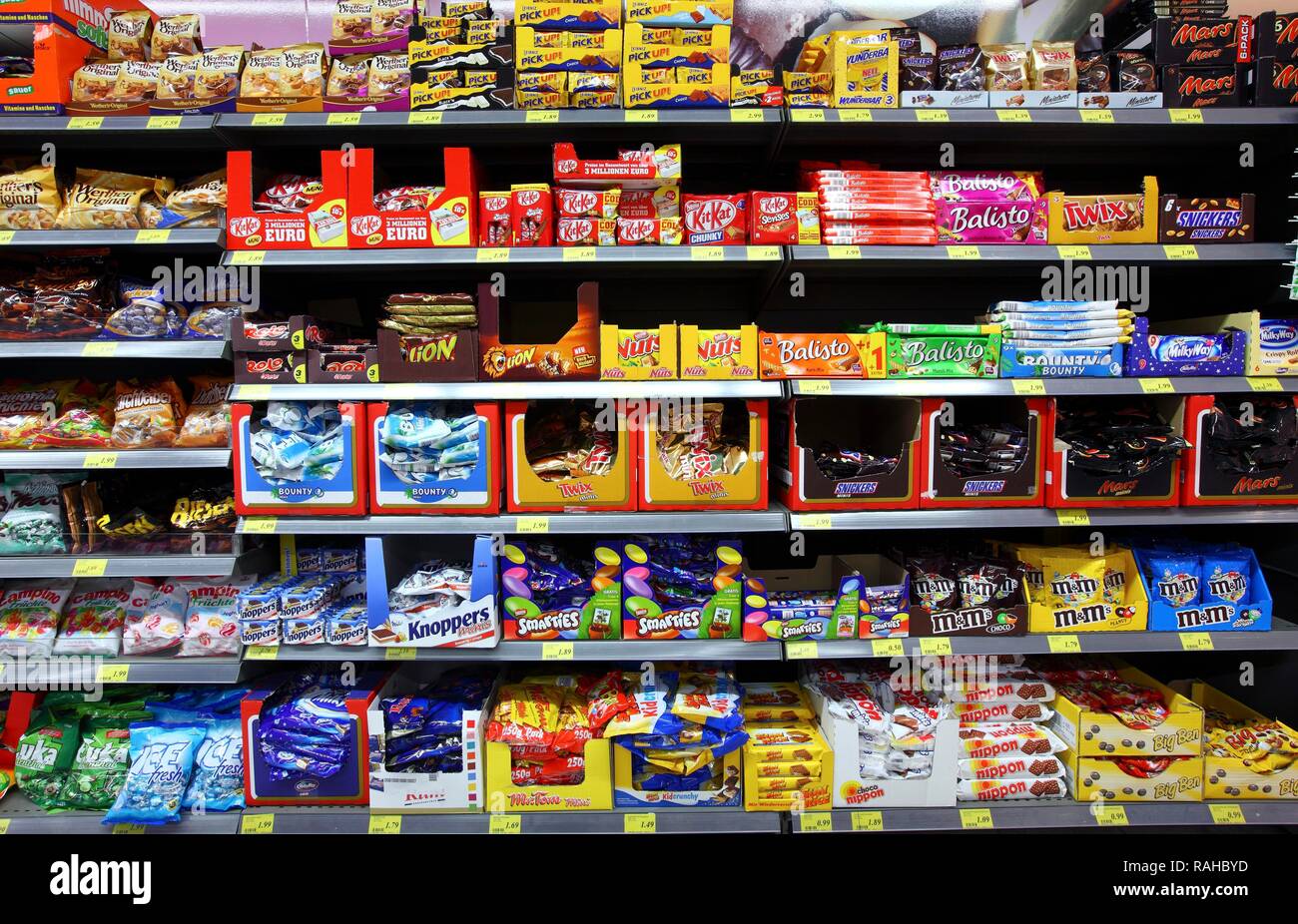Shelves with various candies, chocolate bars, self-service, food department, supermarket Stock Photo
