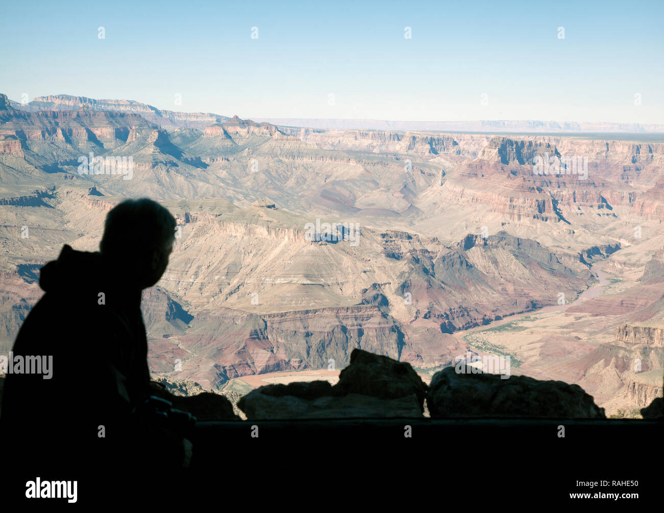 silhouette of man looking out at Grand Canyon from Watchtower at Desert View lookout Stock Photo