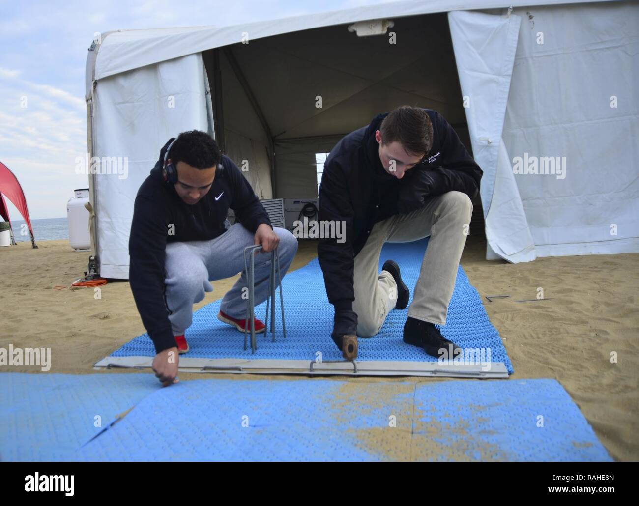 VIRGINIA BEACH, Virginia (Feb. 2, 2017) Information Systems Technician 3rd Class John Broge, from Wyandotte, Michigan and Information Systems Technician 3rd Class Shandon Williams, from Atlanta, put together a ramp. Sailors assigned to the aircraft carrier USS George Washington (CVN 73) volunteered to set up for Polar Plunge 2017  in Virginia Beach. George Washington is homeported in Norfolk preparing to move to Newport News, Virginia for the ship’s refueling complex overhaul (RCOH) maintenance. Stock Photo