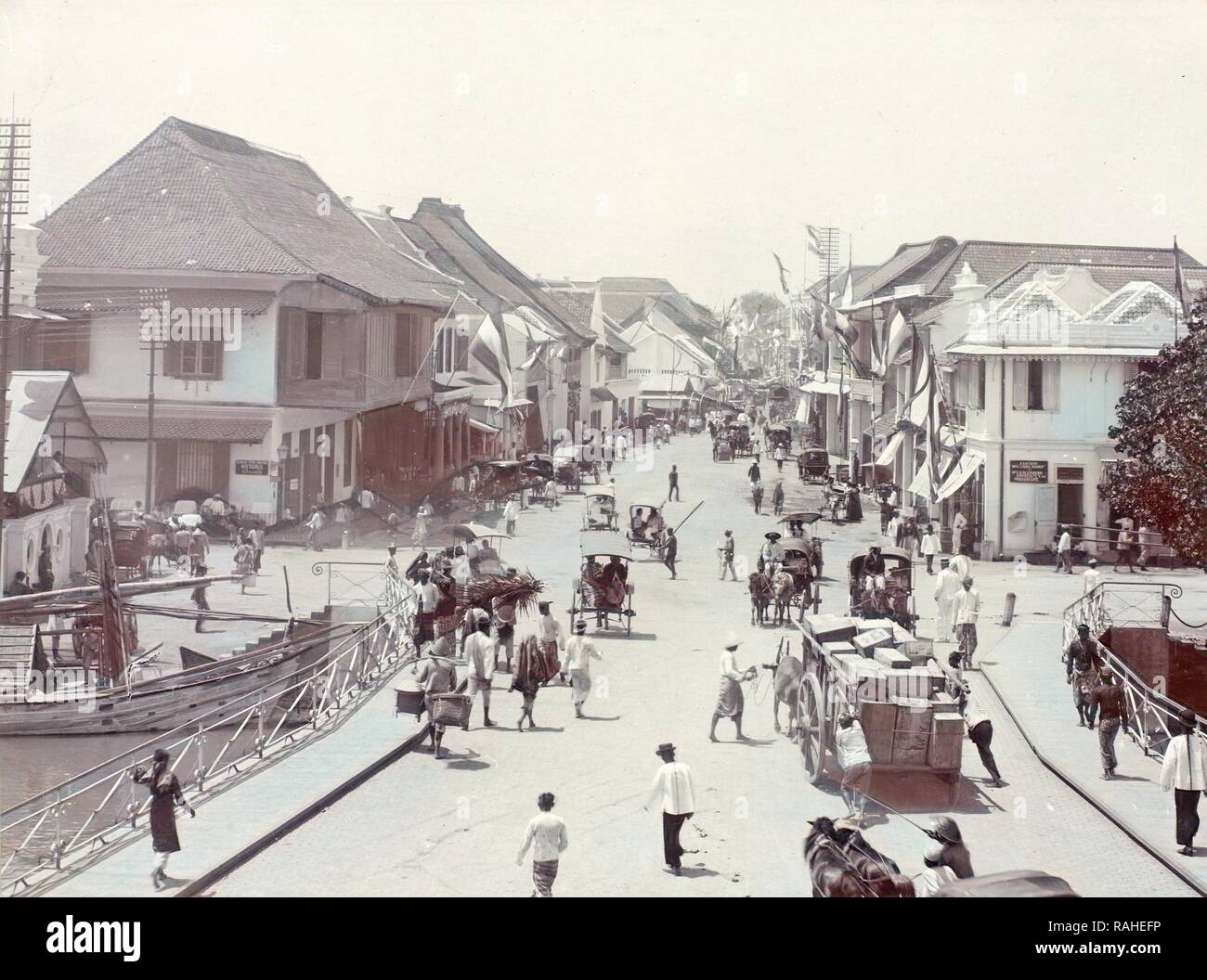 Red Bridge in Surabaya with carts and passersby, Indonesia, Anonymous