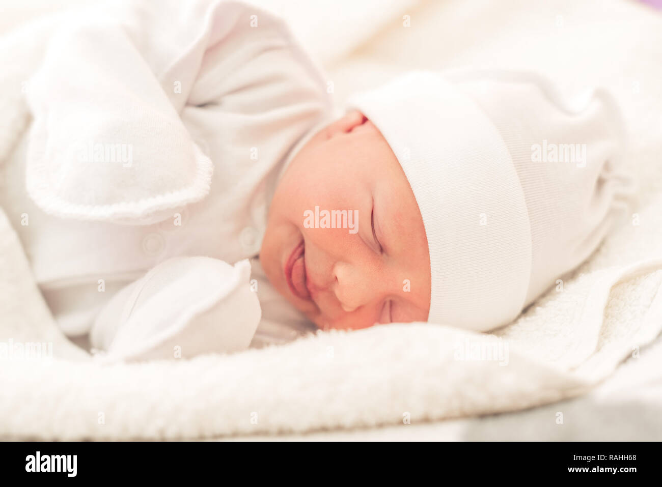 Sleepy baby close-up in a baby cot. Stock Photo