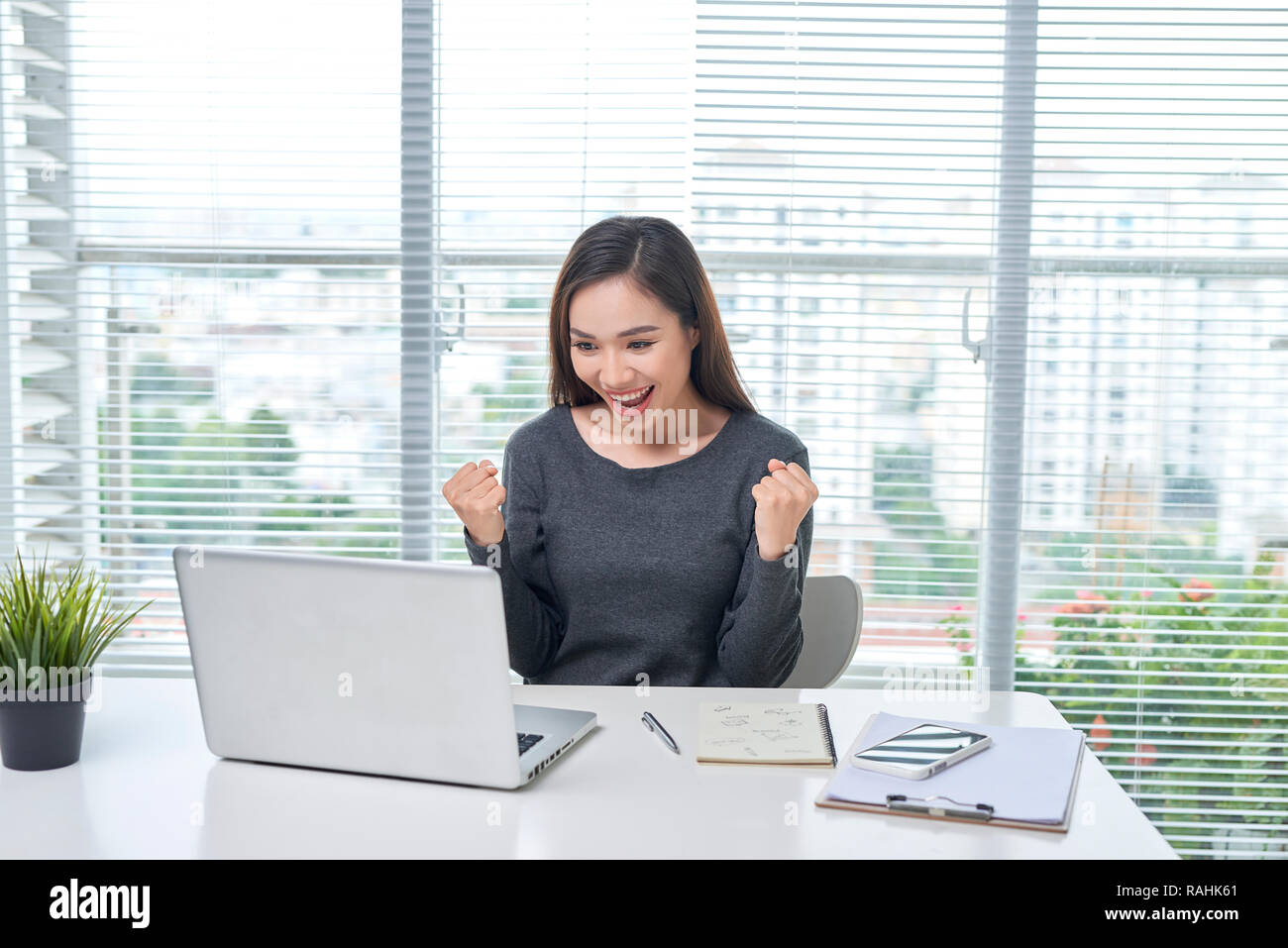 A beautiful lady sitting at a table. Office life. Work place. Stock Photo