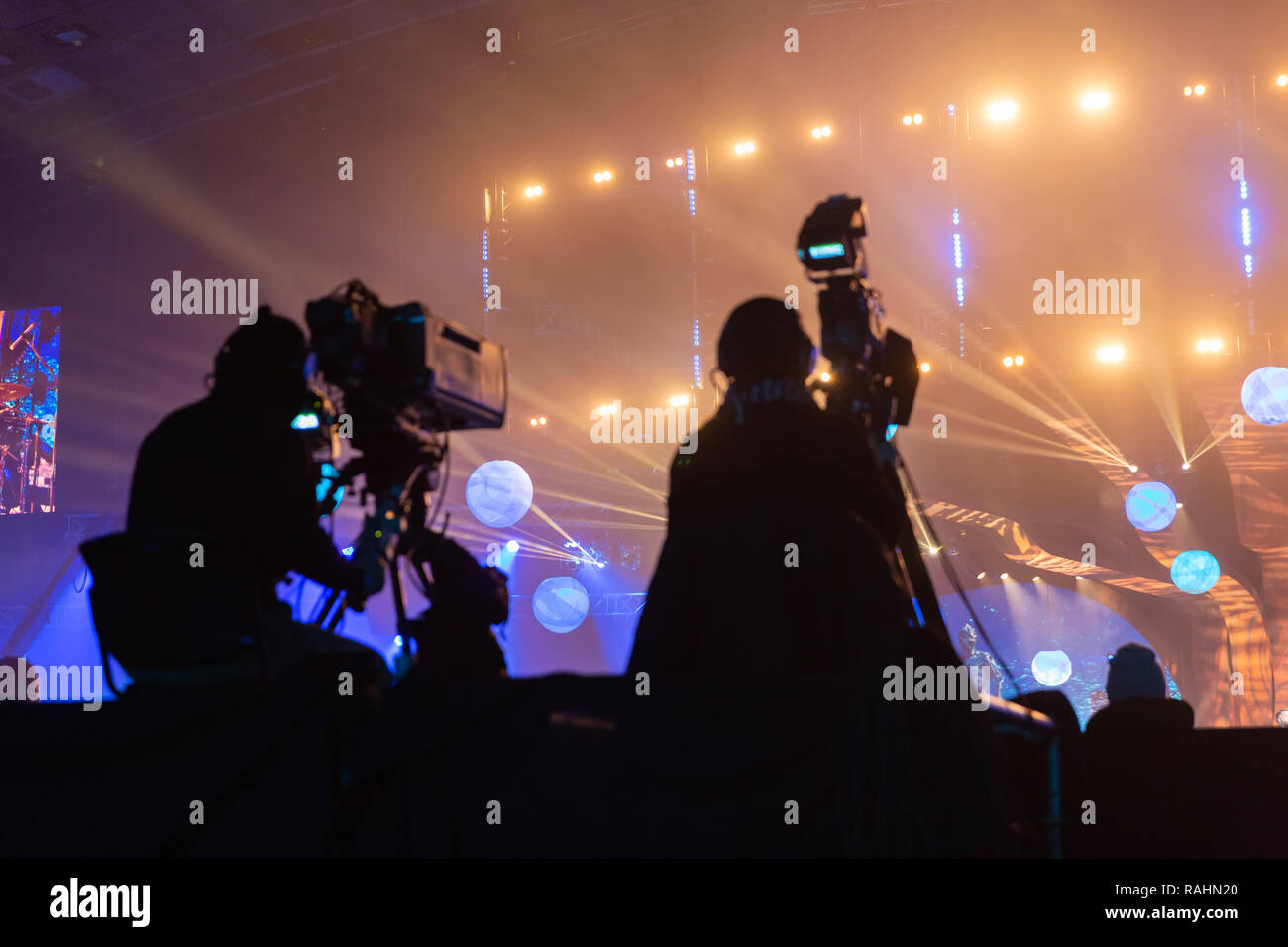 Silhouette of a group of cameramen broadcasting an event. Workers are