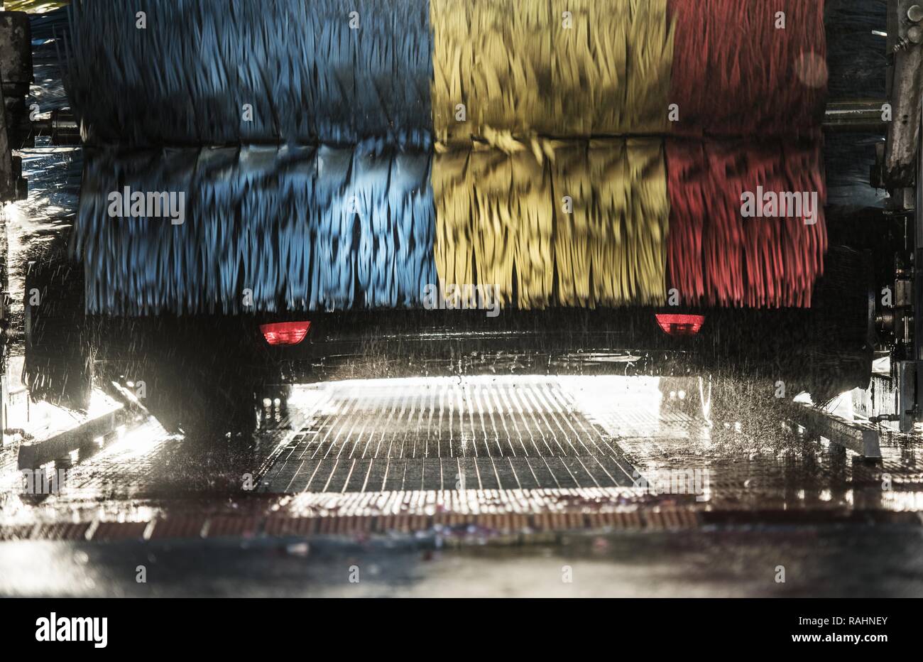 Automatic Car Wash in Progress. Spinning Colorful Brushes Stock Photo