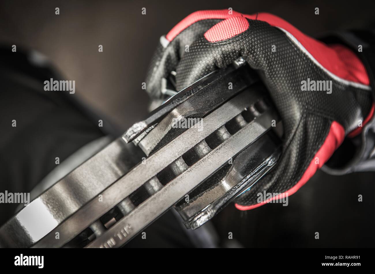 New Car Brakes Installation by Vehicle Mechanic. Disc and Pads Closeup