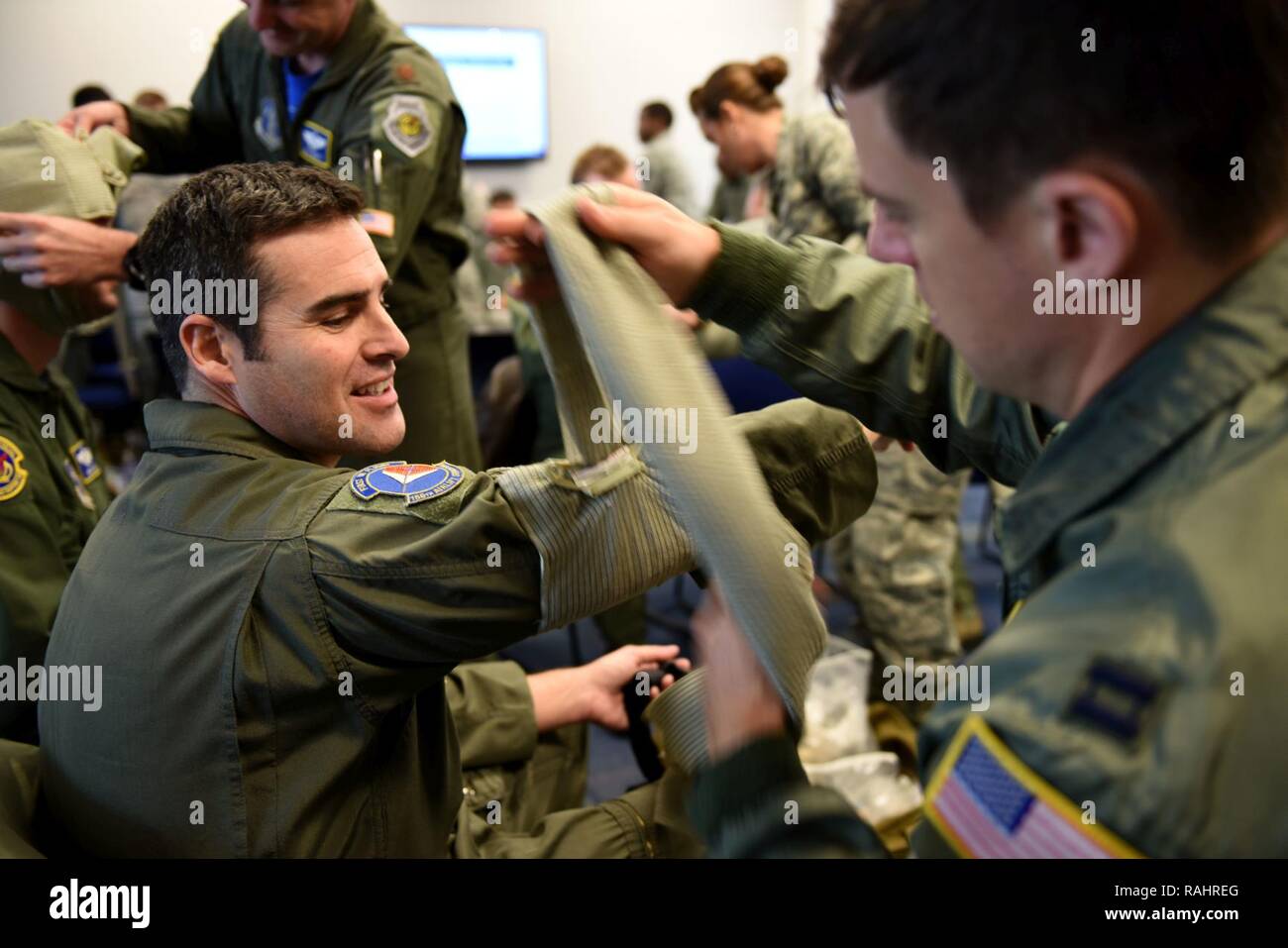U.S. Air Force Capt. Dan Murnane (right), Master Sgt. Chad Wells (left), 145th Airlift Wing, demonstrate how to wrap an injured arm during an Air Expeditionary Skills Rodeo held in a hangar at the North Carolina Air National Guard Base, Charlotte Douglas International Airport, Feb. 4, 2017. The demonstration is part of training for pre-deploying Airmen on self-aid buddy care. Stock Photo