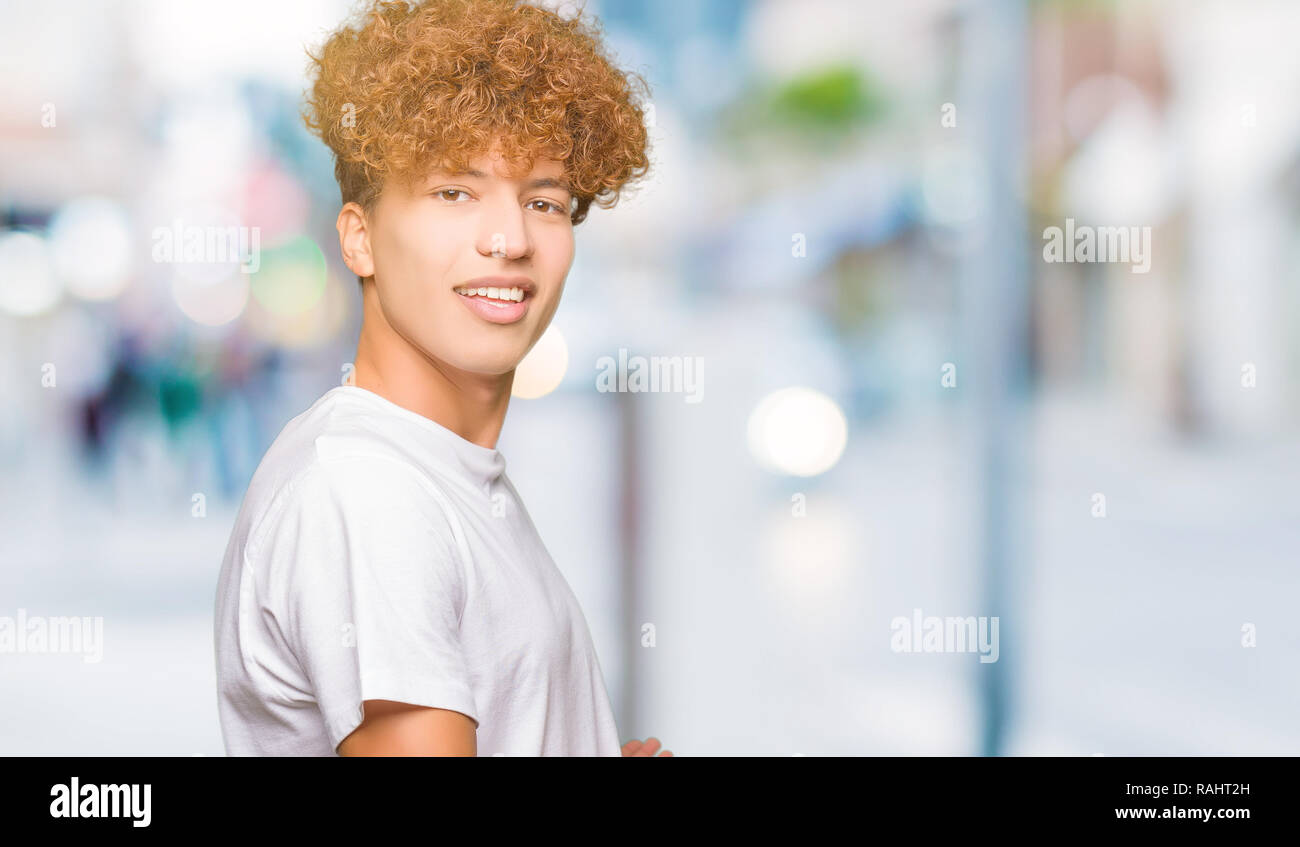 Young Handsome Man With Afro Hair Wearing Casual White T Shirt
