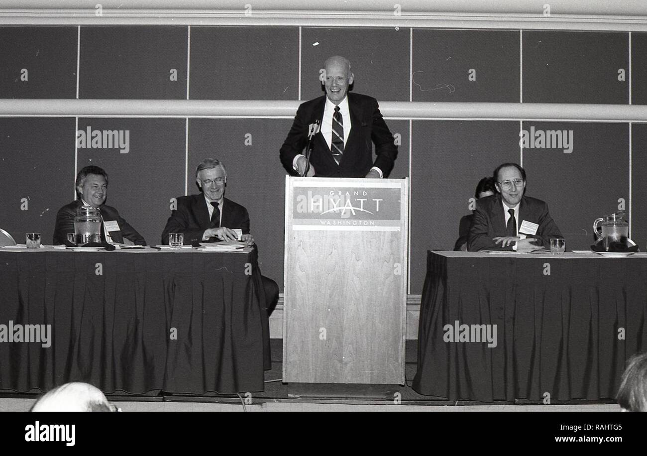MAN AT THE PODIUM GIVING A SPEECH TO A GROUP OF MEN AND WOMEN Stock ...