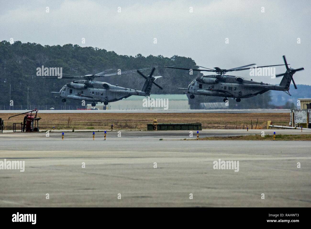 U.S. Marines with Marine Heavy Helicopter Squadron 464 hover CH-53E Super Stallions before a “Max Launch”, Marine Corps Air Station New River, N.C., Feb. 3, 2017. The purpose for this flight is to celebrate a rarely achieved maintenance goal of having all aircraft operational at one time. Stock Photo