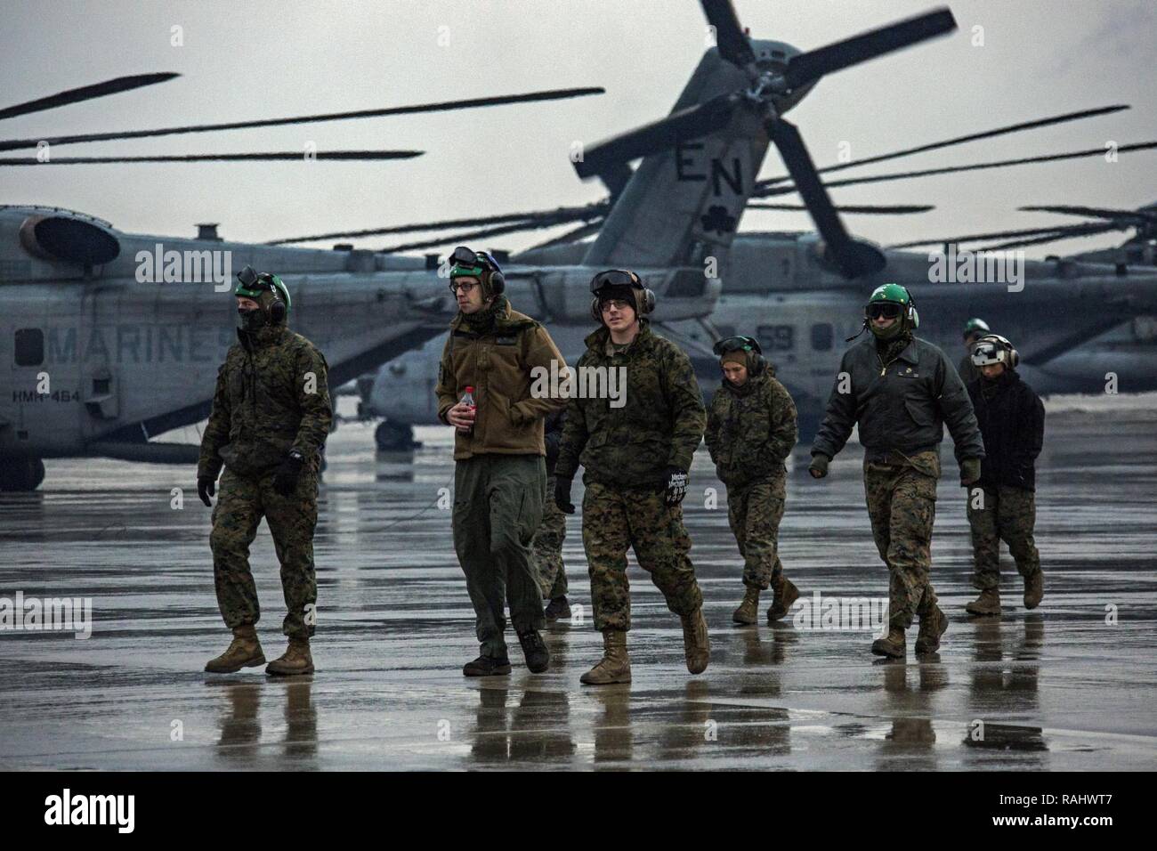 U.S. Marines with Marine Heavy Helicopter Squadron 464 walk to their hanger after conducting a “Max Launch”, Marine Corps Air Station New River, N.C., Feb. 3, 2017. The purpose for this flight is to celebrate a rarely achieved maintenance goal of having all aircraft operational at one time. Stock Photo