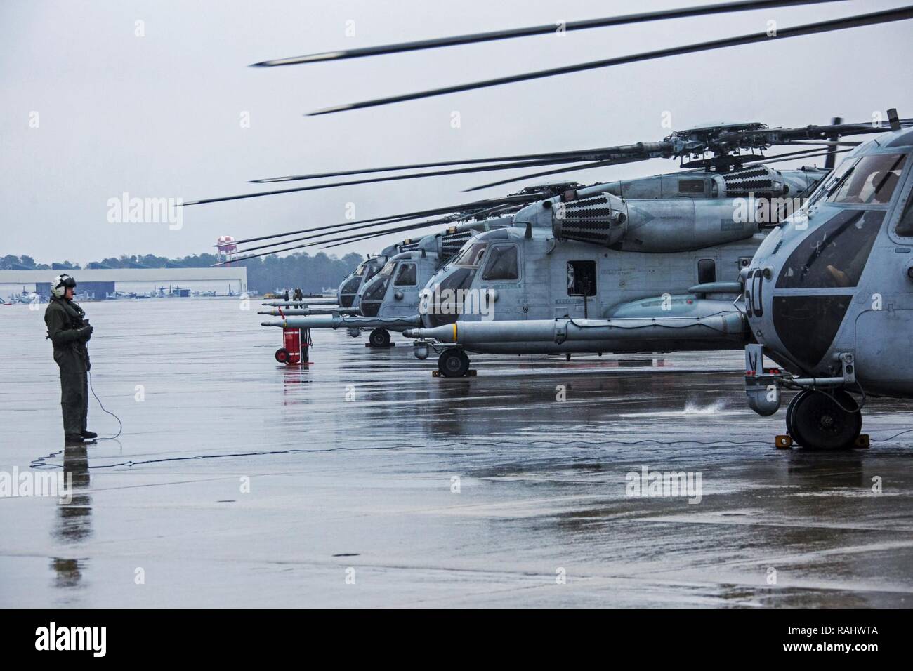 U.S. Marines with Marine Heavy Helicopter Squadron 464 prepare for another take off during a “Max Launch”, Marine Corps Air Station New River, N.C., Feb. 3, 2017. The purpose for this flight is to celebrate a rarely achieved maintenance goal of having all aircraft operational at one time. Stock Photo