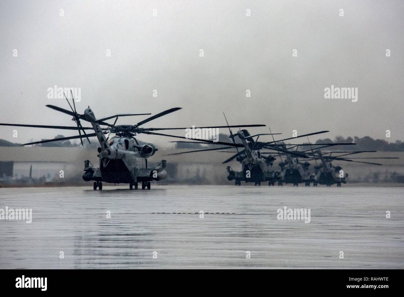 U.S. Marines with Marine Heavy Helicopter Squadron 464 taxi CH-53E Super Stallions and prepare for another take off during a “Max Launch”, Marine Corps Air Station New River, N.C., Feb. 3, 2017. The purpose for this flight is to celebrate a rarely achieved maintenance goal of having all aircraft operational at one time. Stock Photo