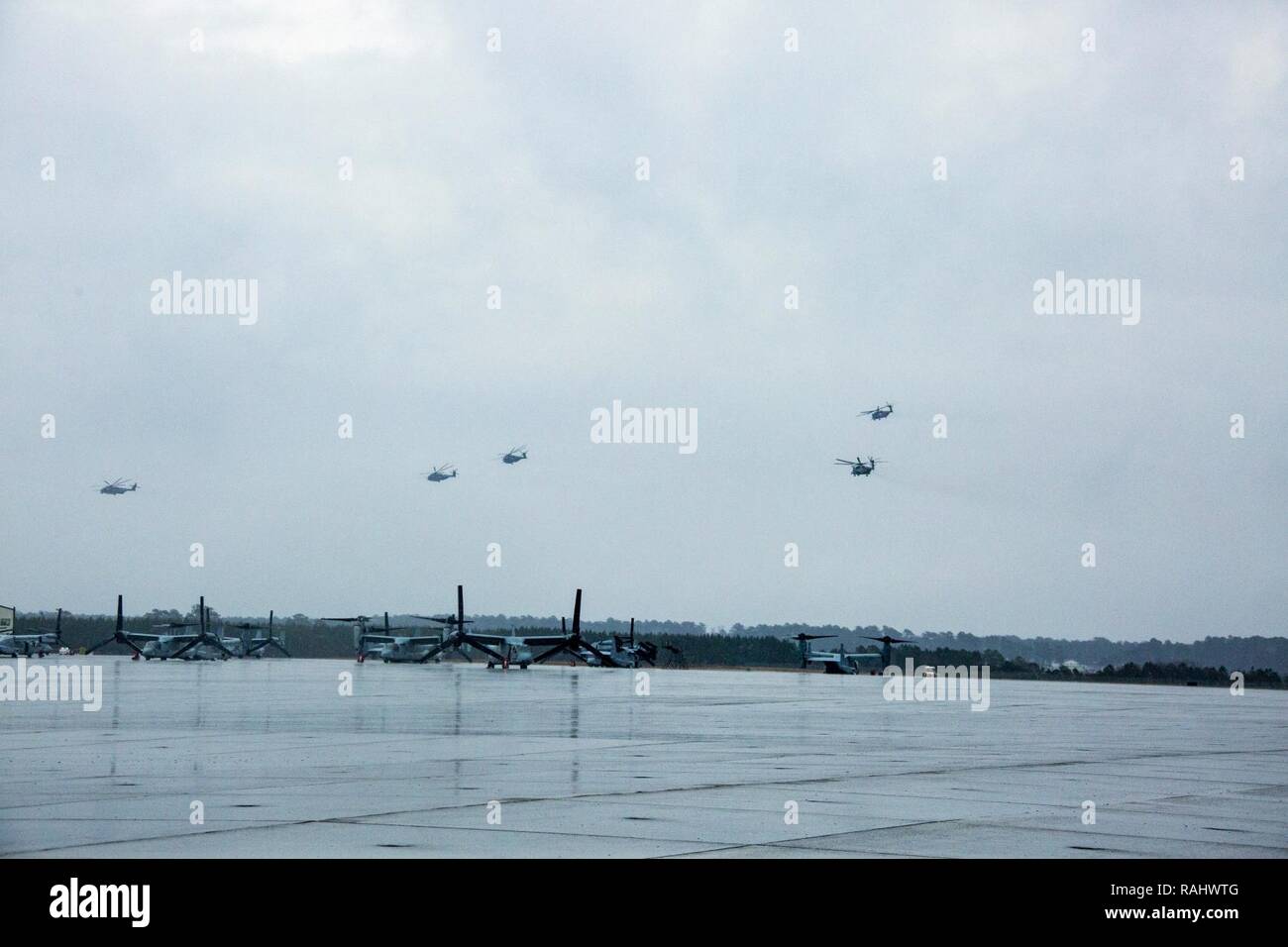 U.S. Marines with Marine Heavy Helicopter Squadron 464 fly in a 'V' formation during a “Max Launch”, Marine Corps Air Station New River, N.C., Feb. 3, 2017. The purpose for this flight is to celebrate a rarely achieved maintenance goal of having all aircraft operational at one time. Stock Photo