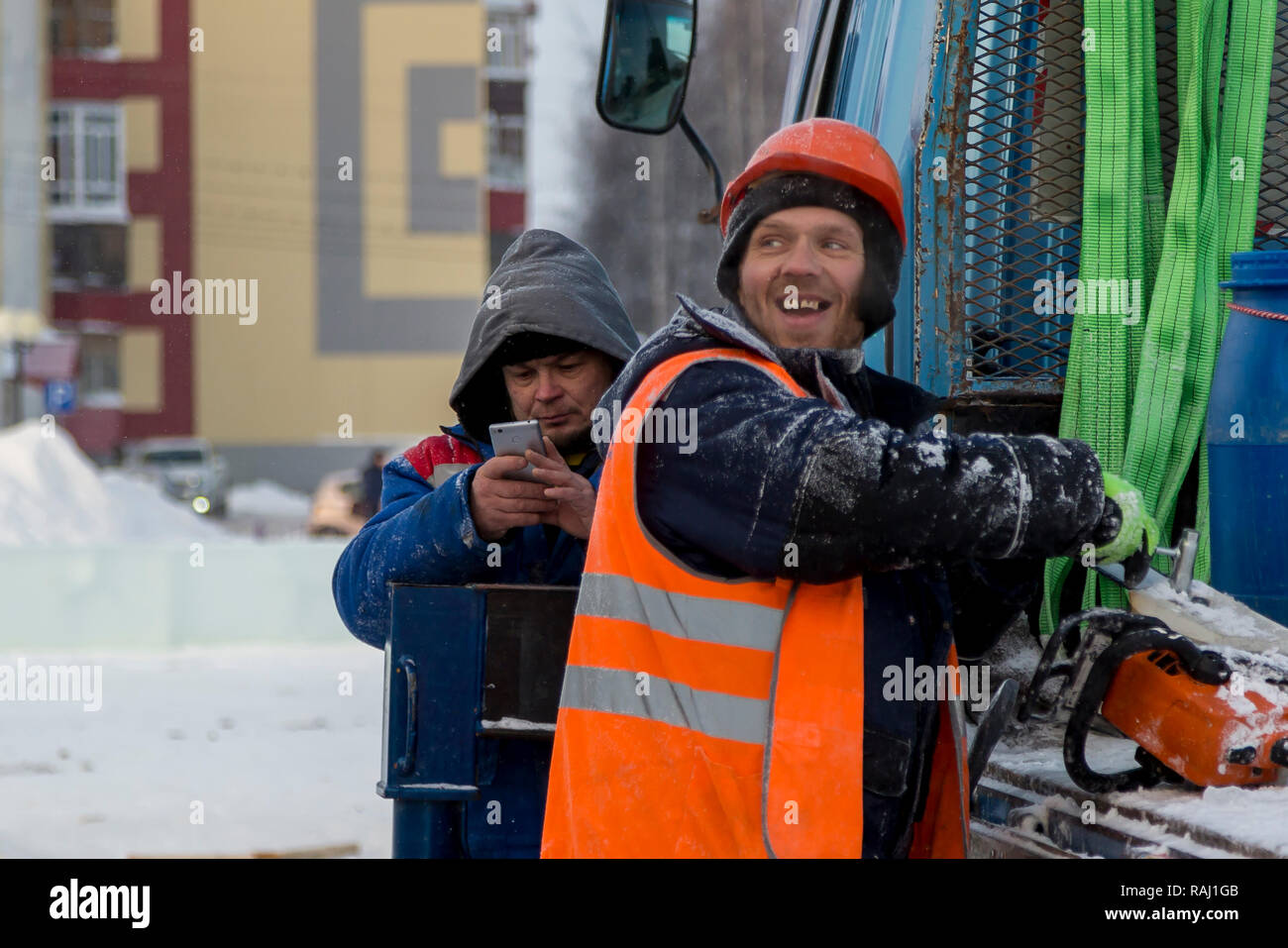 Workers on the construction site of the ice town in a good mood Stock Photo