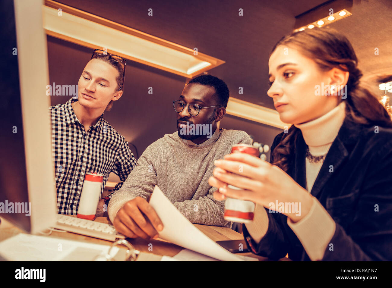 Pleased males looking aside at screen of computer Stock Photo