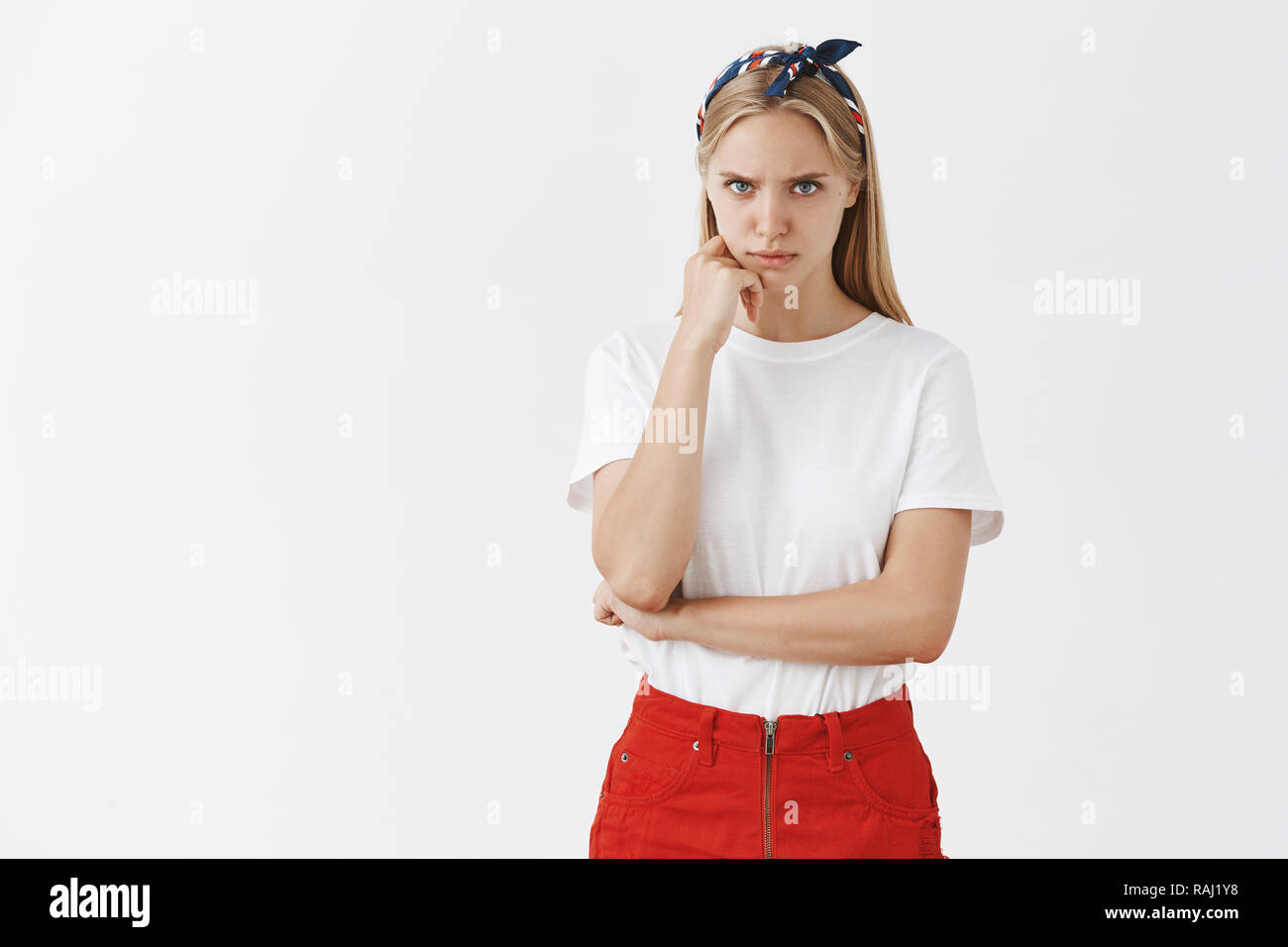 Portrait of angry cute young european female student in trendy headband ...