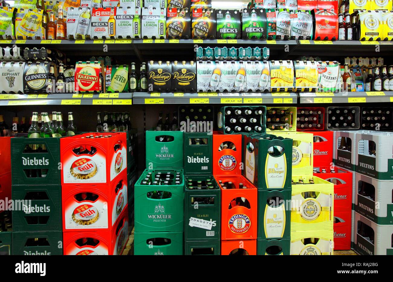 Shelves with different types of beer in six packs and boxes, self-service, food department, supermarket Stock Photo